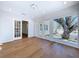 Sun room with wood floors, french doors, lots of light from windows, and leads to an adjacent room at 763 Siesta Dr, Sarasota, FL 34242