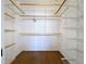 Spacious walk-in closet with wooden shelves and ample storage at 763 Siesta Dr, Sarasota, FL 34242