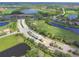 Aerial shot showcasing the community with a golf course, ponds and meticulously manicured landscaping at 7803 Grand Estuary Trl # 205, Bradenton, FL 34212