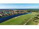Aerial view of the community with homes bordering a golf course and lakes at 7803 Grand Estuary Trl # 205, Bradenton, FL 34212