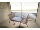 Relaxing balcony overlooking a serene lake view, perfect for outdoor dining and relaxation at 7803 Grand Estuary Trl # 205, Bradenton, FL 34212