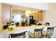 Modern kitchen featuring a breakfast bar with barstool seating and seamless connectivity to the living area at 7803 Grand Estuary Trl # 205, Bradenton, FL 34212