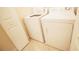 The laundry room has a white washing machine and a white dryer at 7803 Grand Estuary Trl # 205, Bradenton, FL 34212