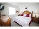 Bright and airy main bedroom with a decorative headboard, plush pillows, and stylish bedside lamps at 7803 Grand Estuary Trl # 205, Bradenton, FL 34212