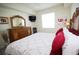 The main bedroom has a large window, mounted TV, and a decorative mirror at 7803 Grand Estuary Trl # 205, Bradenton, FL 34212