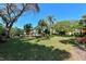 Expansive backyard with lush landscaping, mature trees, and seating areas, providing a serene outdoor space at 811 Oak Dr # 811, Bradenton, FL 34210