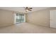 The bedroom has carpet, neutral walls, and a sliding glass door leading to a lanai at 811 Oak Dr # 811, Bradenton, FL 34210