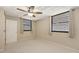 Bedroom with two exterior windows, carpet, and neutral walls at 811 Oak Dr # 811, Bradenton, FL 34210