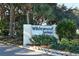 Community sign 'Wildewood Springs' surrounded by lush landscaping at 811 Oak Dr # 811, Bradenton, FL 34210