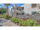 Exterior shot of a two story condo building with wooden stairs, walkway, and garden landscaping at 811 Oak Dr # 811, Bradenton, FL 34210