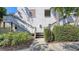 Exterior shot of a two story condo building with wooden stairs, walkway, and garden landscaping at 811 Oak Dr # 811, Bradenton, FL 34210