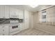 Bright kitchen featuring tile flooring, white cabinetry, and stainless steel appliances at 811 Oak Dr # 811, Bradenton, FL 34210