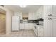 Bright kitchen featuring tile flooring, white cabinetry, and stainless steel appliances at 811 Oak Dr # 811, Bradenton, FL 34210