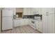 Bright kitchen featuring tile flooring, white cabinetry, and stainless steel appliances at 811 Oak Dr # 811, Bradenton, FL 34210