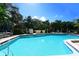 A bright outdoor pool with lounge chairs surrounded by lush greenery offers a relaxing amenity at 811 Oak Dr # 811, Bradenton, FL 34210