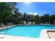 A bright outdoor pool with a grilling area surrounded by lush greenery offers a relaxing amenity at 811 Oak Dr # 811, Bradenton, FL 34210