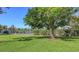 Community tennis court surrounded by lush landscaping and trees at 811 Oak Dr # 811, Bradenton, FL 34210