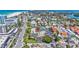 Aerial shot of a building complex with a pool, surrounded by lush greenery and a neighborhood at 845 Benjamin Franklin Dr # 106, Sarasota, FL 34236