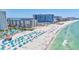 Expansive aerial view of a luxury beachside resort boasting white sand, turquoise water, and beach amenities at 845 Benjamin Franklin Dr # 106, Sarasota, FL 34236