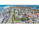 Overhead shot of residential neighborhood near a beach, featuring buildings, parking, and landscaping at 845 Benjamin Franklin Dr # 106, Sarasota, FL 34236