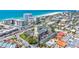 Bird's-eye perspective of a condo building by a beach, complete with parking, landscaping, and neighboring structures at 845 Benjamin Franklin Dr # 106, Sarasota, FL 34236