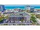 Aerial view of a condo building near a beach, showing the parking lot, landscaping, and surrounding area at 845 Benjamin Franklin Dr # 106, Sarasota, FL 34236