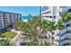 Convenient beach access showcased with lush greenery and palm trees offering a tropical paradise at 845 Benjamin Franklin Dr # 106, Sarasota, FL 34236