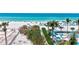 Direct beach access with turquoise water and palm trees, showcasing the ultimate beachfront lifestyle at 845 Benjamin Franklin Dr # 106, Sarasota, FL 34236