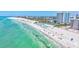 Panoramic view of a vibrant beach with turquoise waters, white sand, and luxury accommodations at 845 Benjamin Franklin Dr # 106, Sarasota, FL 34236