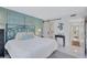 Bright bedroom with stylish bed frame, ample natural light, closet, and ensuite bath at 845 Benjamin Franklin Dr # 106, Sarasota, FL 34236