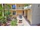 Inviting courtyard with lush landscaping and a cozy grilling area, perfect for outdoor relaxation and entertaining at 845 Benjamin Franklin Dr # 106, Sarasota, FL 34236