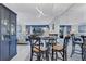 Cozy dining area features a glass table, comfortable seating, and views into the living room at 845 Benjamin Franklin Dr # 106, Sarasota, FL 34236