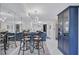 Bright dining area with modern light fixture adjacent to kitchen; ideal for Gathering meals at 845 Benjamin Franklin Dr # 106, Sarasota, FL 34236