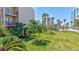 Well-maintained community grounds with manicured lawn and mature palm trees at 845 Benjamin Franklin Dr # 106, Sarasota, FL 34236