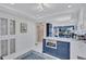 Bright kitchen with a navy blue island and a view into the living and dining areas at 845 Benjamin Franklin Dr # 106, Sarasota, FL 34236