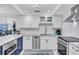 Updated kitchen features white cabinets, stainless steel appliances, and modern countertops at 845 Benjamin Franklin Dr # 106, Sarasota, FL 34236