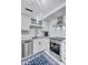 Contemporary kitchen boasts stainless steel appliances, white cabinets, and stylish fixtures at 845 Benjamin Franklin Dr # 106, Sarasota, FL 34236