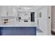 Renovated kitchen with white cabinets, granite counters, and stainless appliances at 845 Benjamin Franklin Dr # 106, Sarasota, FL 34236