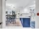 Bright kitchen with white cabinets, center island, and dining area at 845 Benjamin Franklin Dr # 106, Sarasota, FL 34236