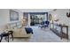 Inviting living room with a comfortable sectional sofa and access to the outdoor patio at 845 Benjamin Franklin Dr # 106, Sarasota, FL 34236