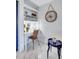 Bright and airy office nook with built-in shelving and a charming nautical-themed clock at 845 Benjamin Franklin Dr # 106, Sarasota, FL 34236