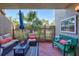 Cozy outdoor patio space with comfortable seating and a view of lush greenery at 845 Benjamin Franklin Dr # 106, Sarasota, FL 34236