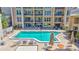 Outdoor pool area with lounge chairs, tables, and umbrellas, perfect for relaxation and recreation at 845 Benjamin Franklin Dr # 106, Sarasota, FL 34236