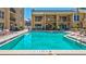 Outdoor pool with clear blue water and seating; a perfect spot to unwind and enjoy the scenery at 845 Benjamin Franklin Dr # 106, Sarasota, FL 34236