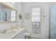 Coastal bathroom featuring a vanity with an ornate mirror and seaside decor, creating a serene and beachy ambiance at 8553 Whispering St, Sarasota, FL 34240
