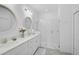 Modern bathroom with dual sinks, a glass-enclosed shower, and white cabinetry at 8553 Whispering St, Sarasota, FL 34240