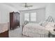 Comfortable bedroom showcasing a decorative iron bed frame, with neutral tones and a classic armoire, offering relaxation at 8553 Whispering St, Sarasota, FL 34240
