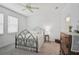Cozy bedroom features soft carpet, a metal frame bed, and natural lighting at 8553 Whispering St, Sarasota, FL 34240