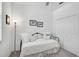 Bedroom featuring a cozy daybed with plush pillows, neutral decor, and a spacious closet, creating a comfortable atmosphere at 8553 Whispering St, Sarasota, FL 34240