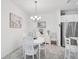 Charming dining area with stylish furniture, complemented by elegant lighting and stainless steel refrigerator at 8553 Whispering St, Sarasota, FL 34240